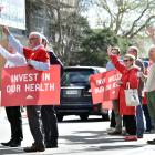 Protesters including Dr Chris Wisely (left) and Lloyd Woods push for better pay and conditions,...