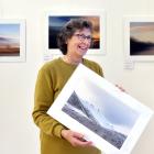 Noelle Bennett holds  The Colour of Cold, in front of her works at photography exhibition ...