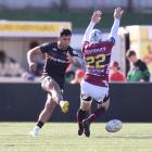 Canterbury midfield back Rameka Poihipi kicks past Southland first five Greg Dyer during the NPC...
