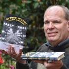 University of Otago Associate Prof Hugh Slotten holds copies of his award-winning book Beyond...