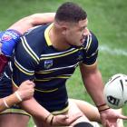 Otago Whalers forward Misinale Fifita gets an offload away despite the attention from Akarana...