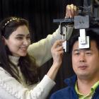 University of Otago PhD student Fateme Mirzaee uses a device to quickly test the neck muscle...