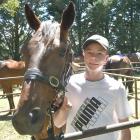 Captain Tom with trainer Alister Black's son Riley, 14, at Omakau Races earlier this year. PHOTO:...