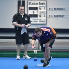 Australian representative Connor Biddle sends down his bowl in front of New Zealand opponent Ross...