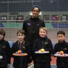 New Zealand tennis player Ajeet Rai  leads Invercargill pupils (from left) Jack Pile, Dexter...