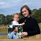 Georgia Redshaw holds a picture of her late fiance Joseph "Moss" Cross and their daughter Breeana...