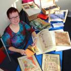 University of Otago Professor Simone Marshall inspects gold leaf and examples of medieval...