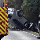 Emergency services at the crash where a car rolled over near Upper Junction on Friday. Photo:...