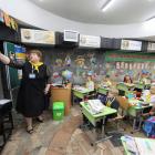 Schoolchildren sit in a classroom set up at a metro station in Kharkiv to avoid air attacks, amid...