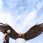 Glenorchy-based sculptor Dan Kelly with the kārearea sculpture he has installed near Clyde. PHOTO...
