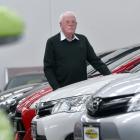 Neil Cottle, of Auto Court, stands amid vehicles eligible for the  clean vehicle discount. Photo:...