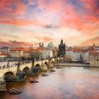 The sun sets on Prague, the capital city of the Czech Republic. The pedestrian Charles Bridge is...