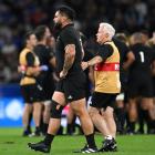 All Blacks prop Tyrel Lomax is helped off the field by physio Pete Gallagher after suffering an...