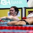 New Zealand swimmer Erika Fairweather (left) reacts after winning the women's 400m freestyle...