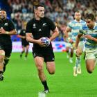All Black wing Will Jordan steams past Argentina's Juan Cruz Mallia  during their Rugby World Cup...