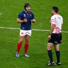 Antoine Dupont speaks with New Zealand referee Ben O’Keeffe during the quarterfinal against South...