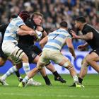 All Black Ethan de Groot (with ball) is tackled by Matias Alemanno of Argentina during the Rugby...