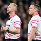 Referee Wayne Barnes and assistant referee Matthew Carley watch the big screen as the TMO reviews...