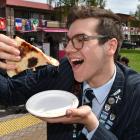 King’s High School head boy Massimo Pezzuto, who has Italian heritage, tucks into pizza during a...