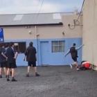 King’s High School pupils watch while a pupil from another school is kicked on the ground. PHOTO:...