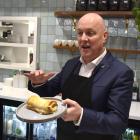Christopher Luxon sampling a cheese roll in Invercargill. PHOTO: ODT FILES