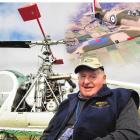 Warbirds Over Wanaka founder Sir Tim Wallis sits in front of his restored Hiller 12E, the third...