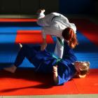 Libby Ralston, 14, topples her regular sparring partner and coach Nikita Wright, 14. PHOTOS:...