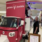 Gelato Junkie staff member Gilian Hersche hands a gelato cone to customer Shelley Amezcua at the...