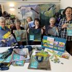 Celebrating the book bags sewn by Stitch Kitchen volunteers from old council banners for the Read...