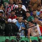 Fans clash in the stands with security staff caused a delay to the start of the match. Photo:...