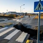 This photo taken on November 13 shows a crack cutting across the main road in Grindavik,...