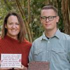 Tania Ranby (left) and Jack Piggott-Newton with the two plaques he made her after the Massey mum...