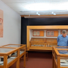 Reed rare books librarian Julian Smith inspecting the gallery's Glory of Print exhibition