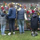 Dunedin residents gather to place flowers to mark the death of children in Gaza since the...