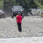 A protester from the Ashley Rakahuri Rivercare Group stands in front of 4WDs racing down the...