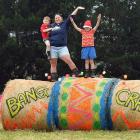 Sara Davis with sons Issac (3) and William (6) on their Christmas hay bale display, south of...