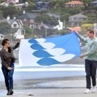 St Clair Esplanade Hydro building trustee Katherine Greer with Jeremiah Hall and his winning flag...