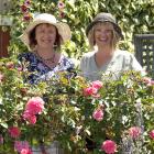 Tania Blakely (left) and Jackie Sutherland, both from Alexandra, admire the roses in Bill May’s...