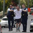 Armed police take a man into custody after an incident in Mitchell Ave on Friday morning. PHOTO:...
