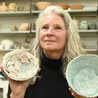 Otago Potters Group committee member Mary Schollum displays two of her soda-fired pieces at the...