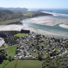 The popular seaside town of Pounawea lies between the Owaka river (left) and the Catlins river...