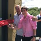 Mayor Tim Cadogan and pool committee chairwoman Sally Feinerman cut the ribbon to open the Ida...