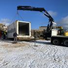 Containers are lifted into place at the Snow Farm at the beginning of winter 2023 for staff and...