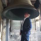 Waitaki District Mayor Gary Kircher stands under the largest of the five bells inside the clock...