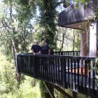 Dave and Lisa North on the balcony of the main unit of Te Aka Native Forest Retreat -- 6m above...
