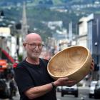 Dunedin man Jonathan Leichter holds a bowl made by his son Sam Leichter using a large catalpa...