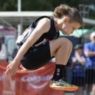 Zac Grant (Remarkable Runners) flies toward the sand during the boys grade 10 long jump at the...