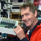 University of Otago physicist Dr Tim Molteno works on a piece of his latest transient array radio...