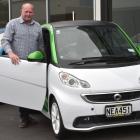 Auto Court Dunedin manager Nelson Cottle stands with an electric car on his forecourt. PHOTO:...