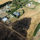 Dramatic images capture the scorched earth mere metres away from homes and buildings. Photo:...